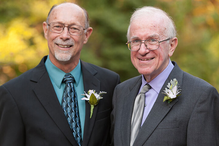 John Cleland with Dr. Einhorn dressed in suites stand together.
